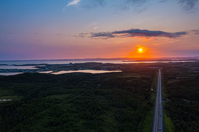 As the sun sets over Newfoundland nature paints a masterpiece in hues of gold and pink