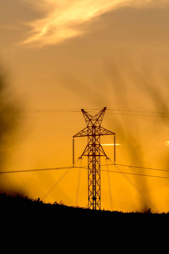 Transmission tower in sunset